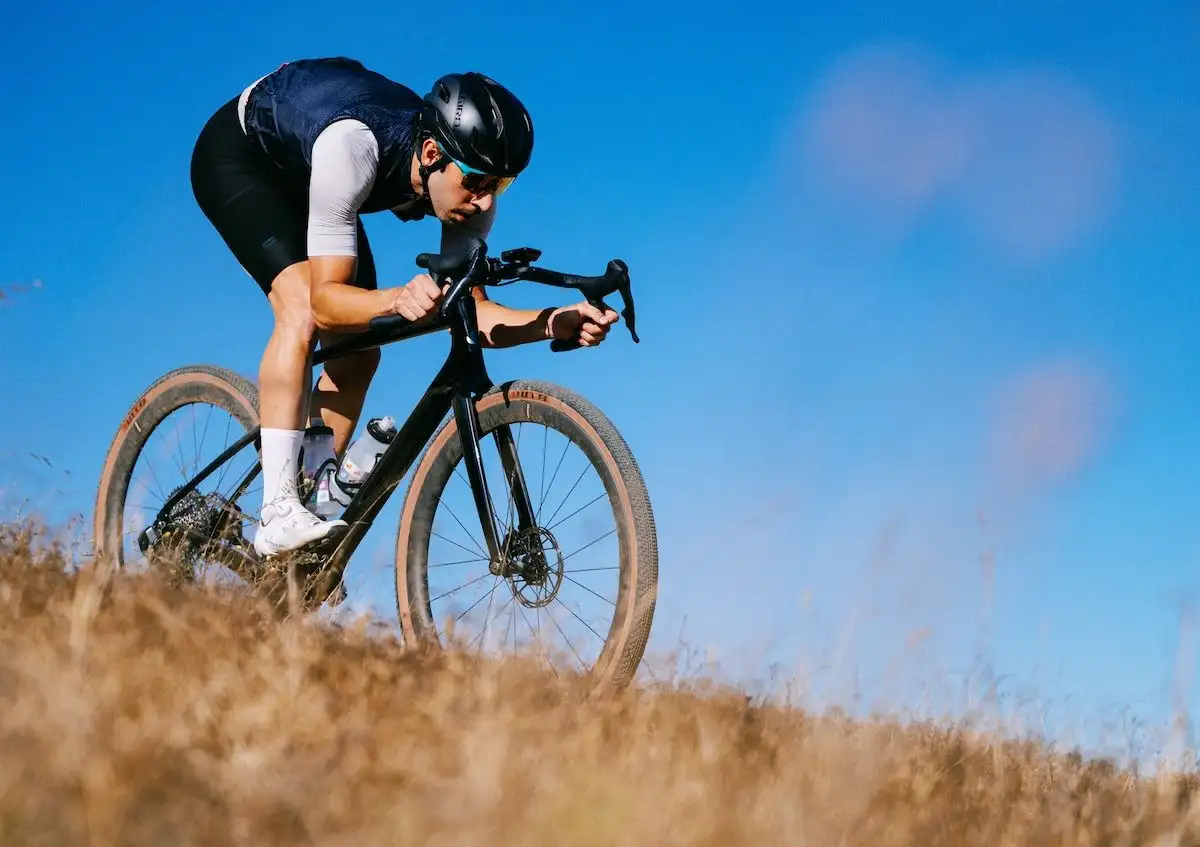 Man rides downhill on a gravel bike