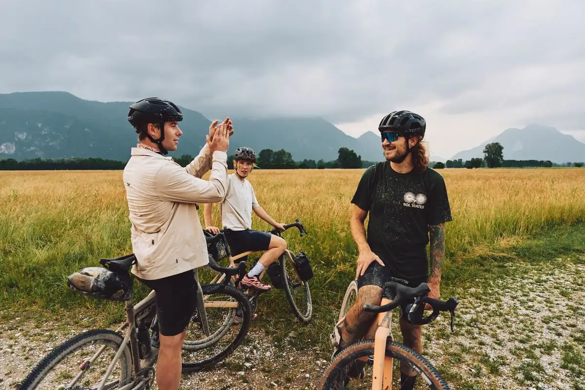 multiple people in a good mood with bikes taking a break in the nature