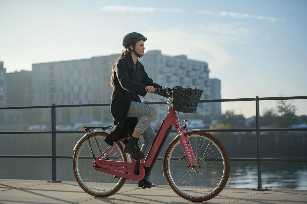 woman riding cube bike in a city