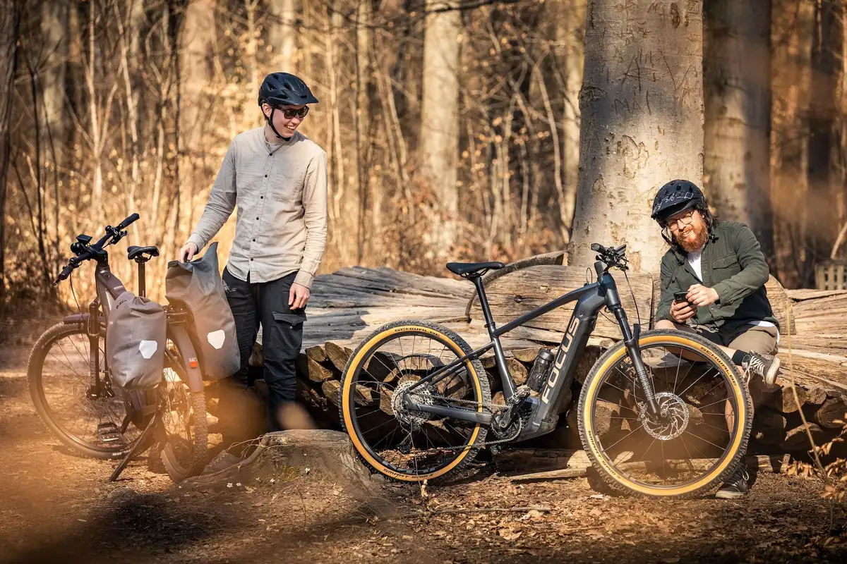 Zwei Mountainbiker machen Pause im Wald