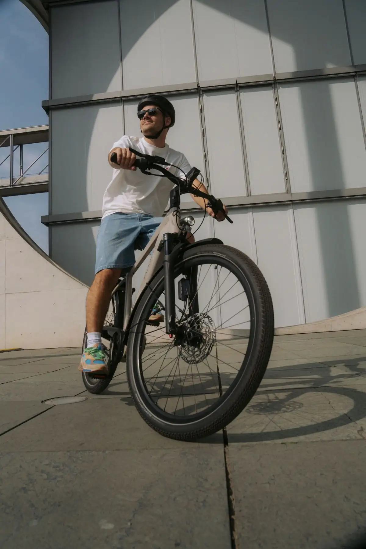 Man sitting on an e-bike in the city in summer