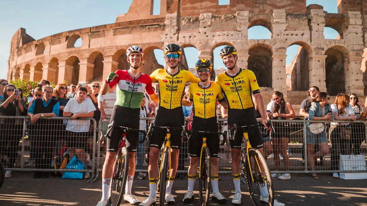 Team Visma | Lease a Bike riders posing in front of the Colosseum in Rome.